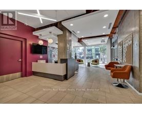 A reception area with a red door and a flat screen TV mounted on the wall.