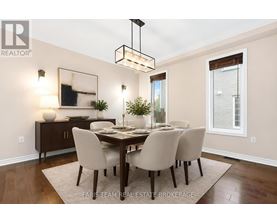 A dining room with a wooden table and chairs.