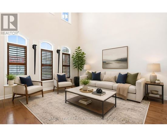 A living room with a white couch, a coffee table, and a painting on the wall.