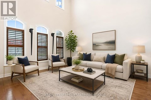 A living room with a white couch, a coffee table, and a painting on the wall.