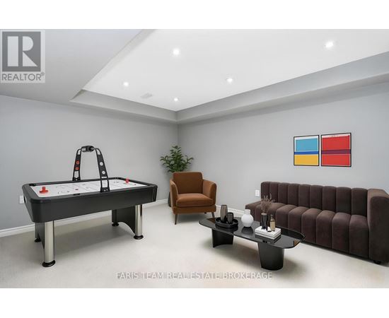 A room with a pool table, couch, and chair.