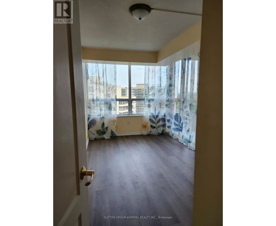 A room with a view of the city through the window.
