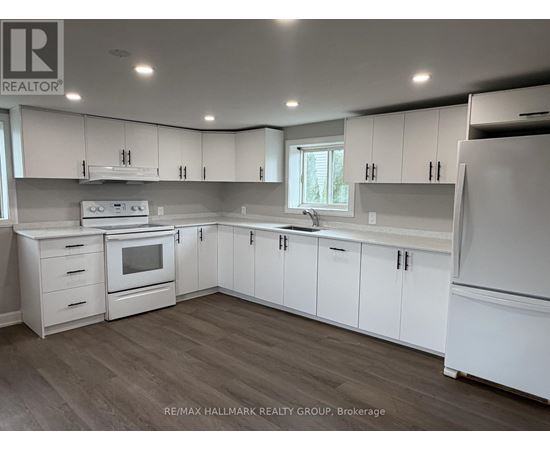A kitchen with white cabinets and appliances.