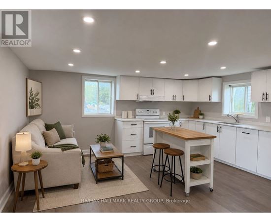 A well-lit, modern kitchen with white cabinets and a wooden island.