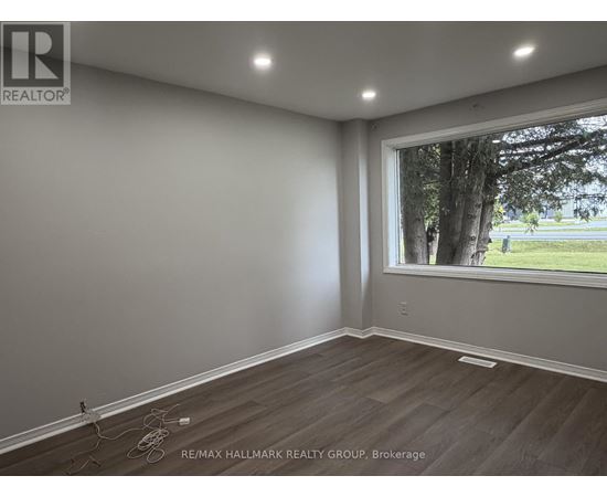 A room with a window showing trees outside.