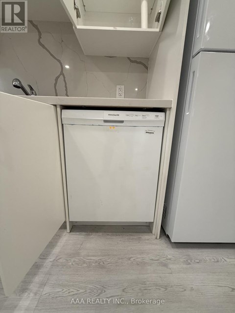 A white dishwasher is in the kitchen.