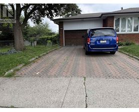 A blue car is parked in front of a house.