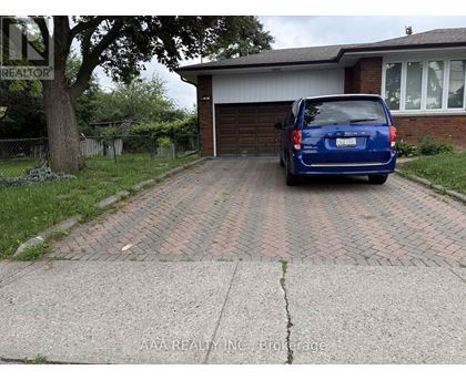 A blue car is parked in front of a house.