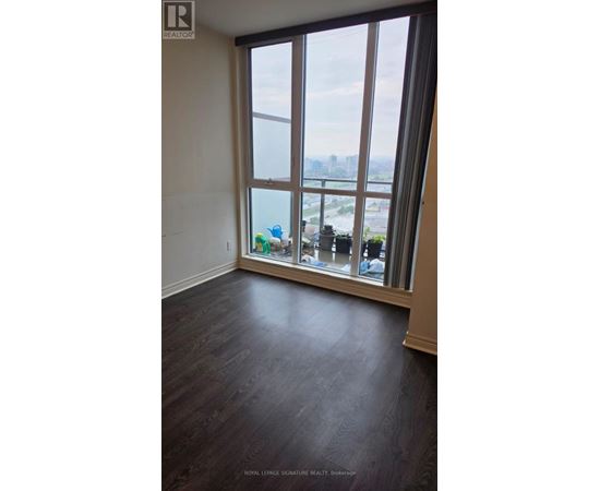 A room with a large window overlooking a cityscape.