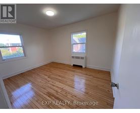 A room with wooden flooring and a window.