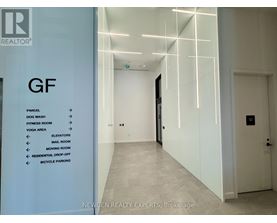 A hallway with a sign on the left side listing amenities.