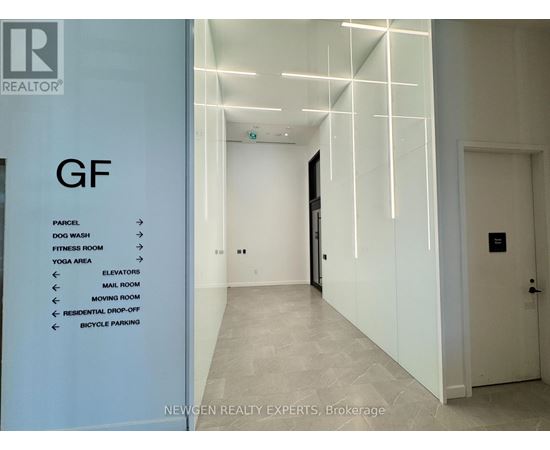 A hallway with a sign on the left side listing amenities.