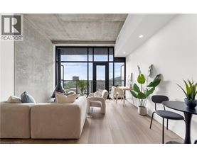 A living room with a large window and a view of the city.