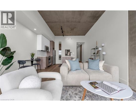 A living room with a white sofa and a coffee table.