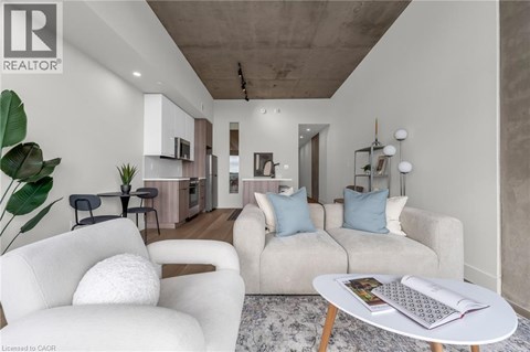A living room with a white sofa and a coffee table.