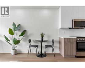 A modern kitchen with a table and chairs.