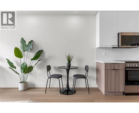 A modern kitchen with a table and chairs.