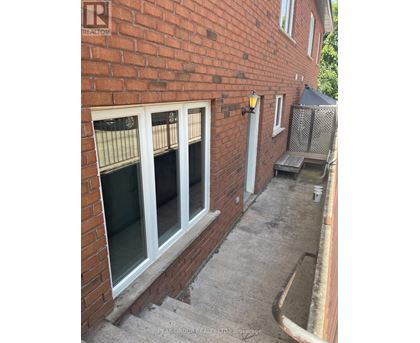 A brick house with a window and a door.