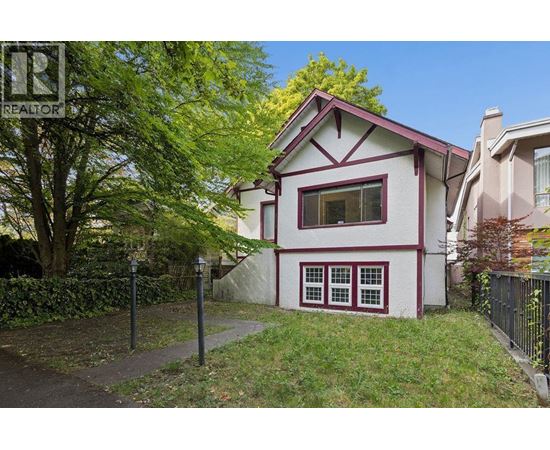 A house with a red roof and white walls with a red window trim.