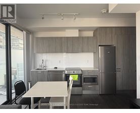 A modern kitchen with a table and chairs.
