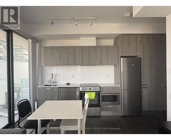 A modern kitchen with a table and chairs.