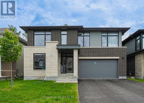 A modern house with a garage is for sale.