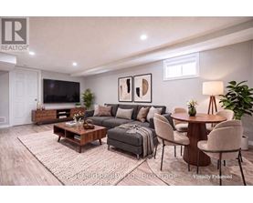 A living room with a grey couch, a wooden coffee table, and a flat screen TV.