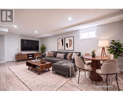 A living room with a grey couch, a wooden coffee table, and a flat screen TV.