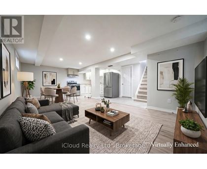 A well-lit, modern living room with a grey sofa and a wooden coffee table.