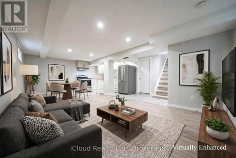 A well-lit, modern living room with a grey sofa and a wooden coffee table.