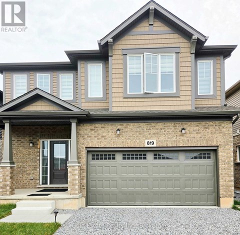 A house with a grey garage door is for sale.