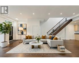 A spacious living room with a staircase and a coffee table.