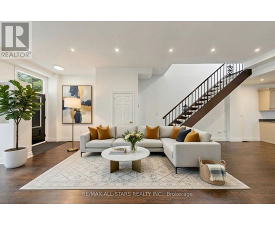 A spacious living room with a staircase and a coffee table.