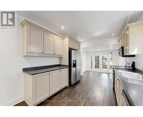 A kitchen with wooden cabinets and a black countertop.