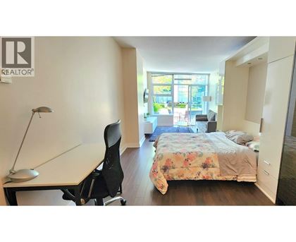 A bedroom with a bed, desk, and chair.