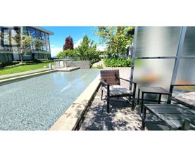 A pool with a chair and table beside it.