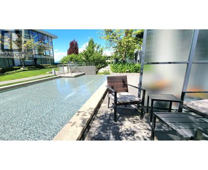 A pool with a chair and table beside it.