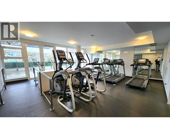 A gym with treadmills and elliptical machines.