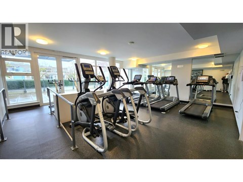 A gym with treadmills and elliptical machines.