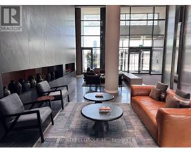 A waiting area with leather couches and chairs.