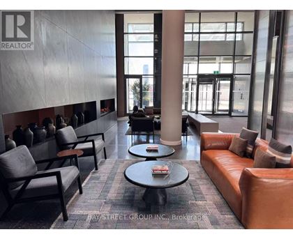 A waiting area with leather couches and chairs.