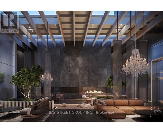 A modern living room with a large couch and a chandelier.