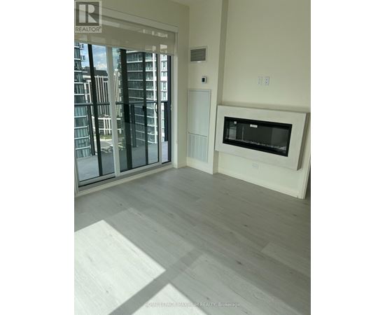 A modern living room with a large window and a built-in TV.