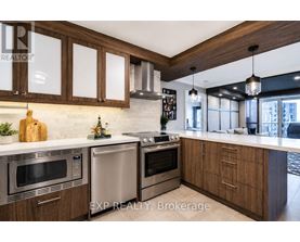 A modern kitchen with wooden cabinets and stainless steel appliances.