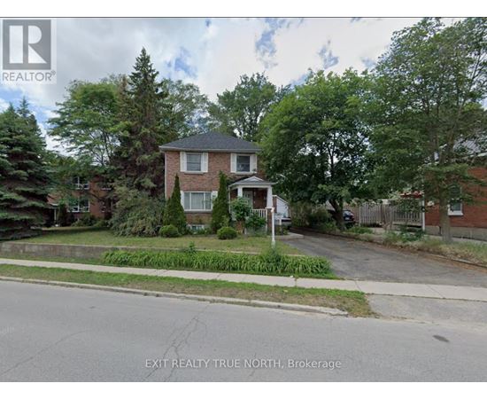 A house with a lawn in front of it is for sale.
