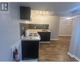 A kitchen with a black countertop and a white stove top oven.
