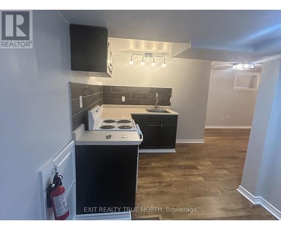 A kitchen with a black countertop and a white stove top oven.