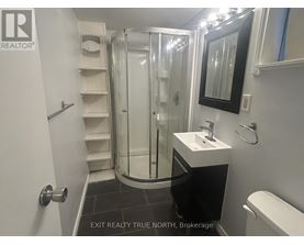 A bathroom with a sink, toilet and shower.