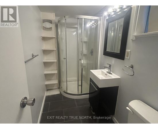A bathroom with a sink, toilet and shower.