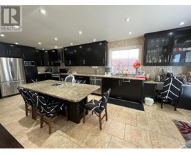 A kitchen with a table and chairs in the middle of it.